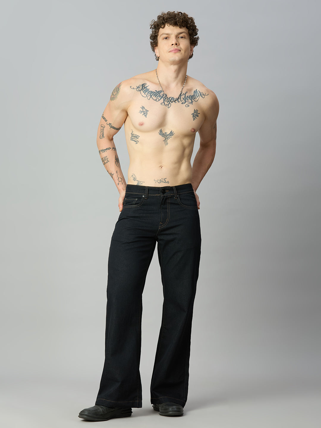 Model wearing The Lofa men's deep blue bootcut denim jeans styled for a modern casual look