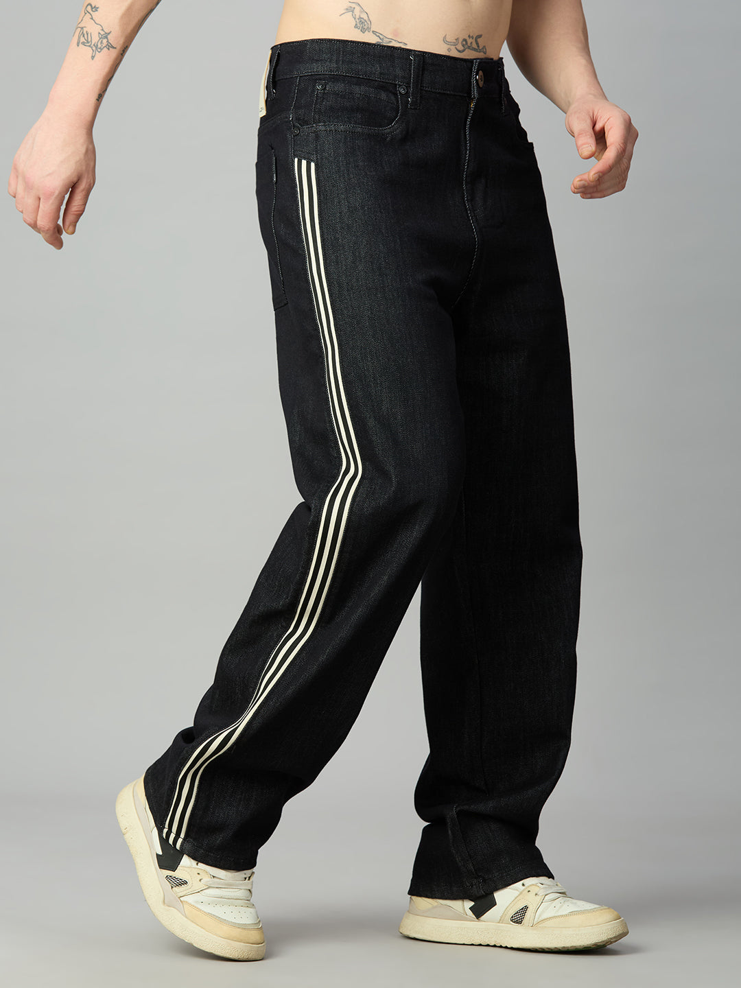 Men's baggy raw black denim jeans with contrast side stripe detailing – right side view