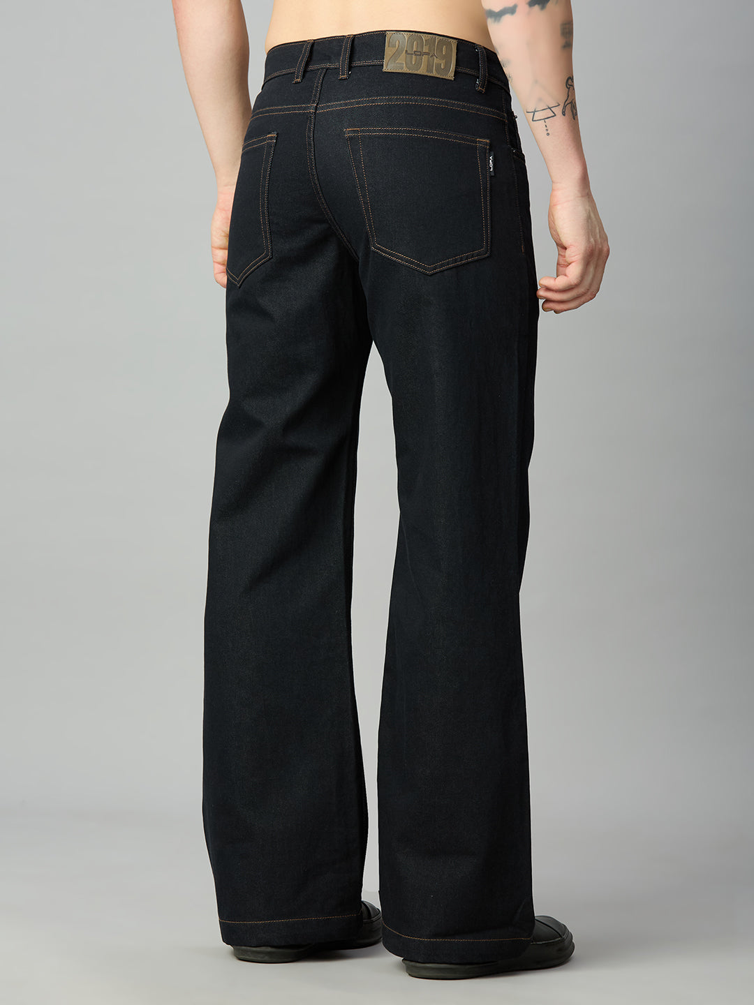 Men's deep blue bootcut jeans featuring classic back pockets and premium denim – back view