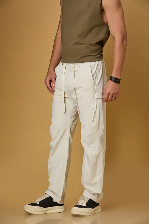 Beige stretchable trousers side view showing two side pockets and relaxed fit.