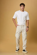 Men wearing LOFA beige cargo pants in a casual outdoor setting.