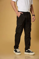 black pants side view showing double cargo pockets and relaxed fit.