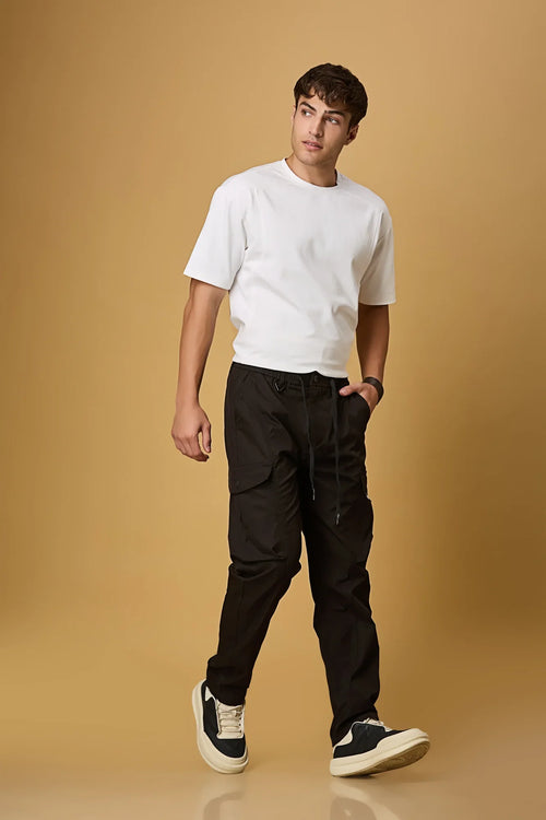 Men wearing LOFA black cargo pants in a casual outdoor setting.