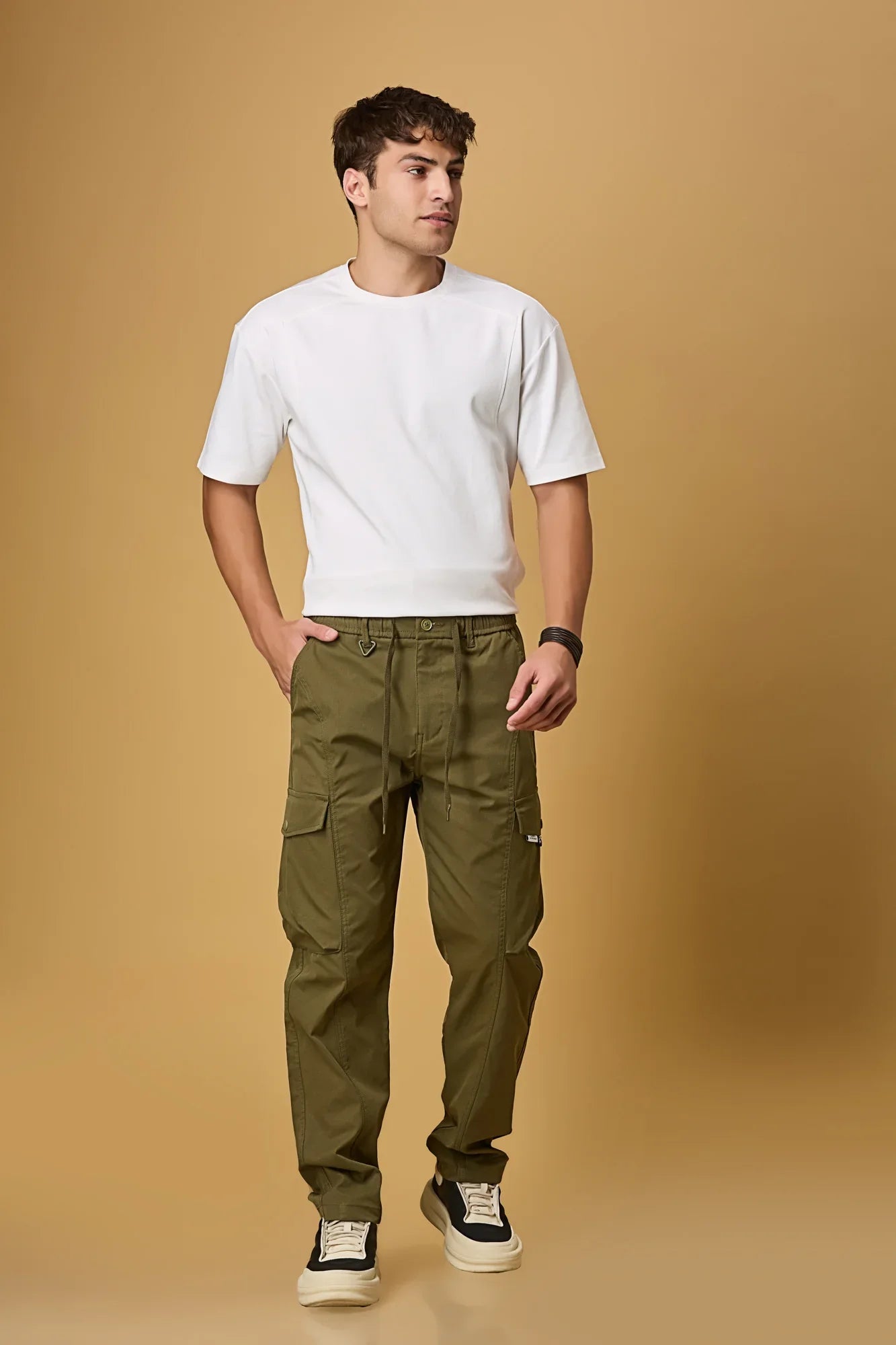 Men wearing LOFA Mehndi Green cargo pants in a casual outdoor setting.