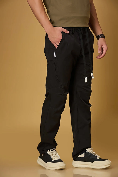 Black stretchable trousers side view showing two side pockets and relaxed fit.