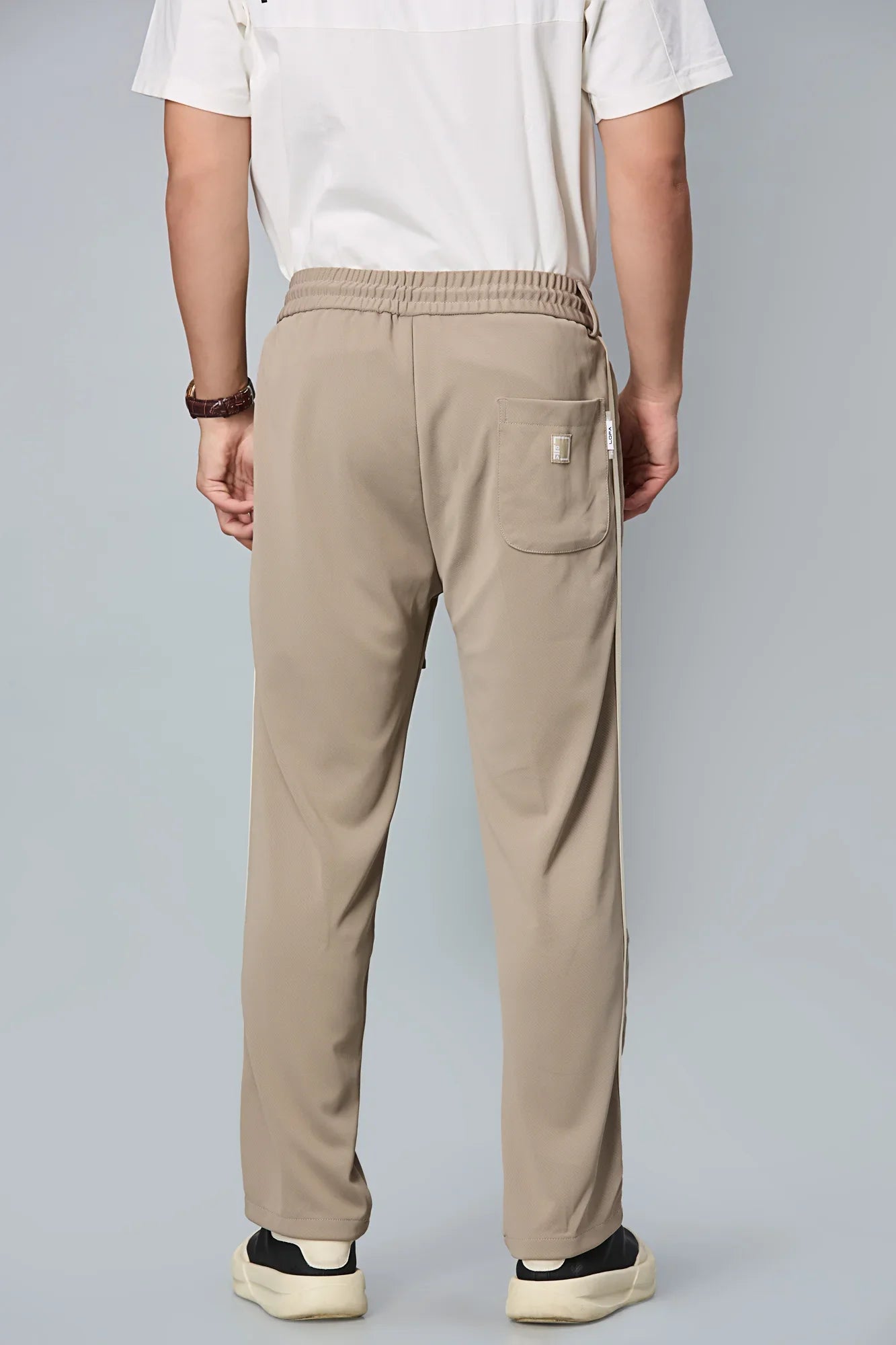 Back view of LOFA straight-fit men’s active pants – clean silhouette with wrinkle-resistant fabric.