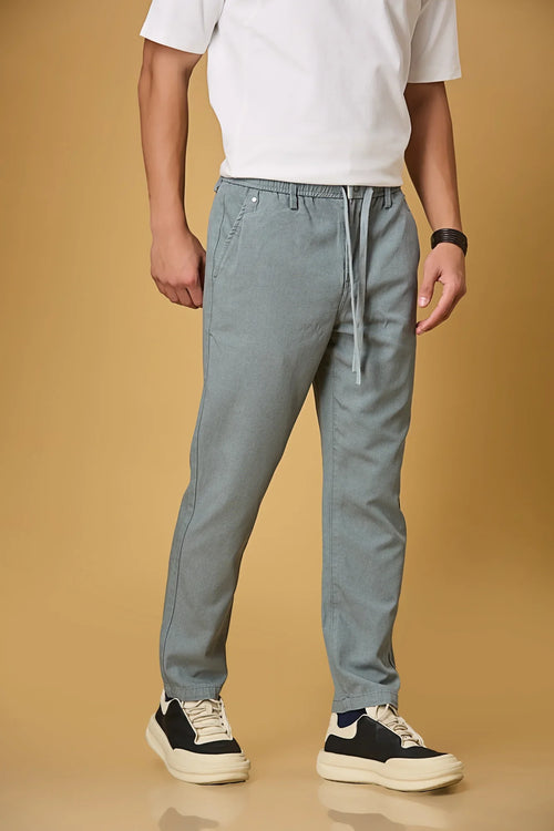 Close-up of waist string, press button, and fabric texture on Aqua Blue trousers.