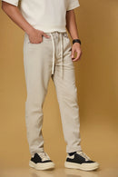 Beige stretchable trousers side view showing casual comfort fit.