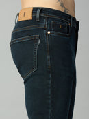 Close-up of waistband, button closure, and premium stitching on men's dark wash stretch denim jeans
