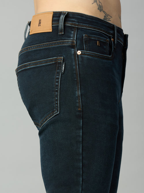 Close-up of waistband, button closure, and premium stitching on men's dark wash stretch denim jeans