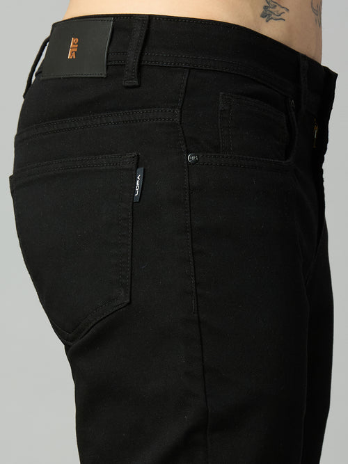 Close-up of waistband, button closure, and premium stitching on men's pitch black stretch denim jeans