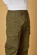 Close-up of Mehndi Green cargo pants, waist string and pocket detailing.