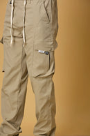 Close-up of Khaki cargo pants, waist string and pocket detailing.