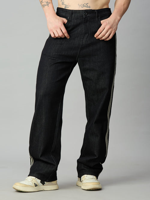 Men's raw black baggy denim jeans with double contrast side stripes – front view