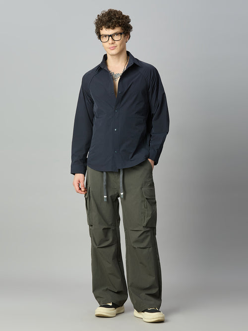 Model wearing relaxed fit cargo pants with casual streetwear styling