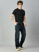 Model wearing The Lofa men's baggy stretch denim jeans with green side stripes and drawstring waistband for a modern streetwear look
