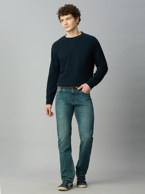 Model wearing The Lofa men's light blue-green straight fit denim jeans with an attached web belt for a modern casual look