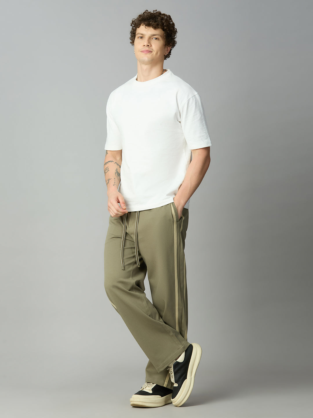 Model wearing Lofa™ baggy smart pants with side stripes styled for modern streetwear and casual everyday wear
