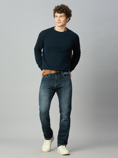 Model wearing The Lofa men's straight fit deep blue washed denim jeans with attached adjustable belt for a modern streetwear look