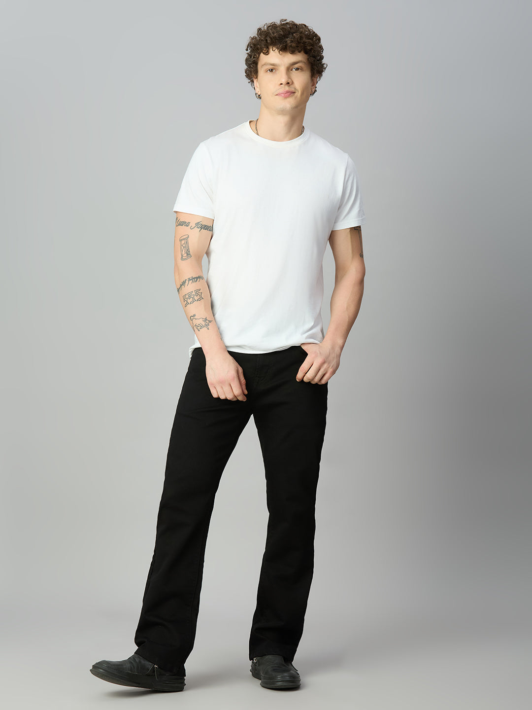 Model wearing The Lofa men's pitch black straight fit stretch denim jeans styled for a clean modern everyday look