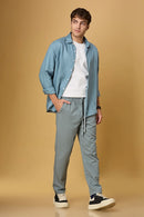 Men wearing LOFA Aqua Blue Tencel-cotton trousers in a relaxed casual setting.