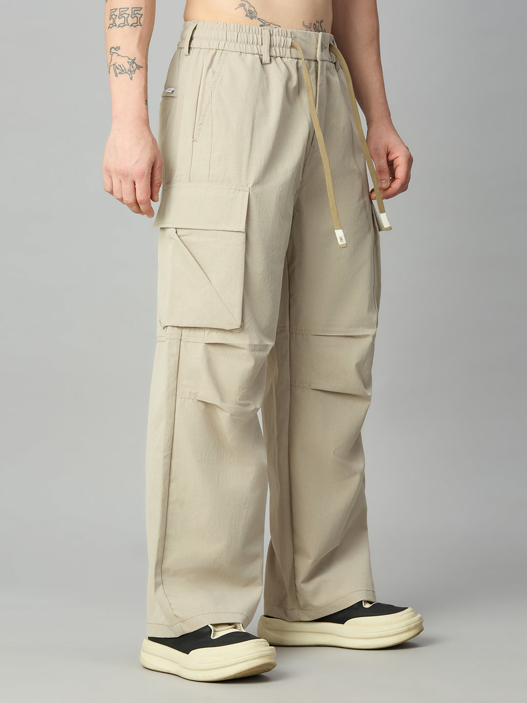 Men's relaxed fit cargo pants left side view showing utility pockets