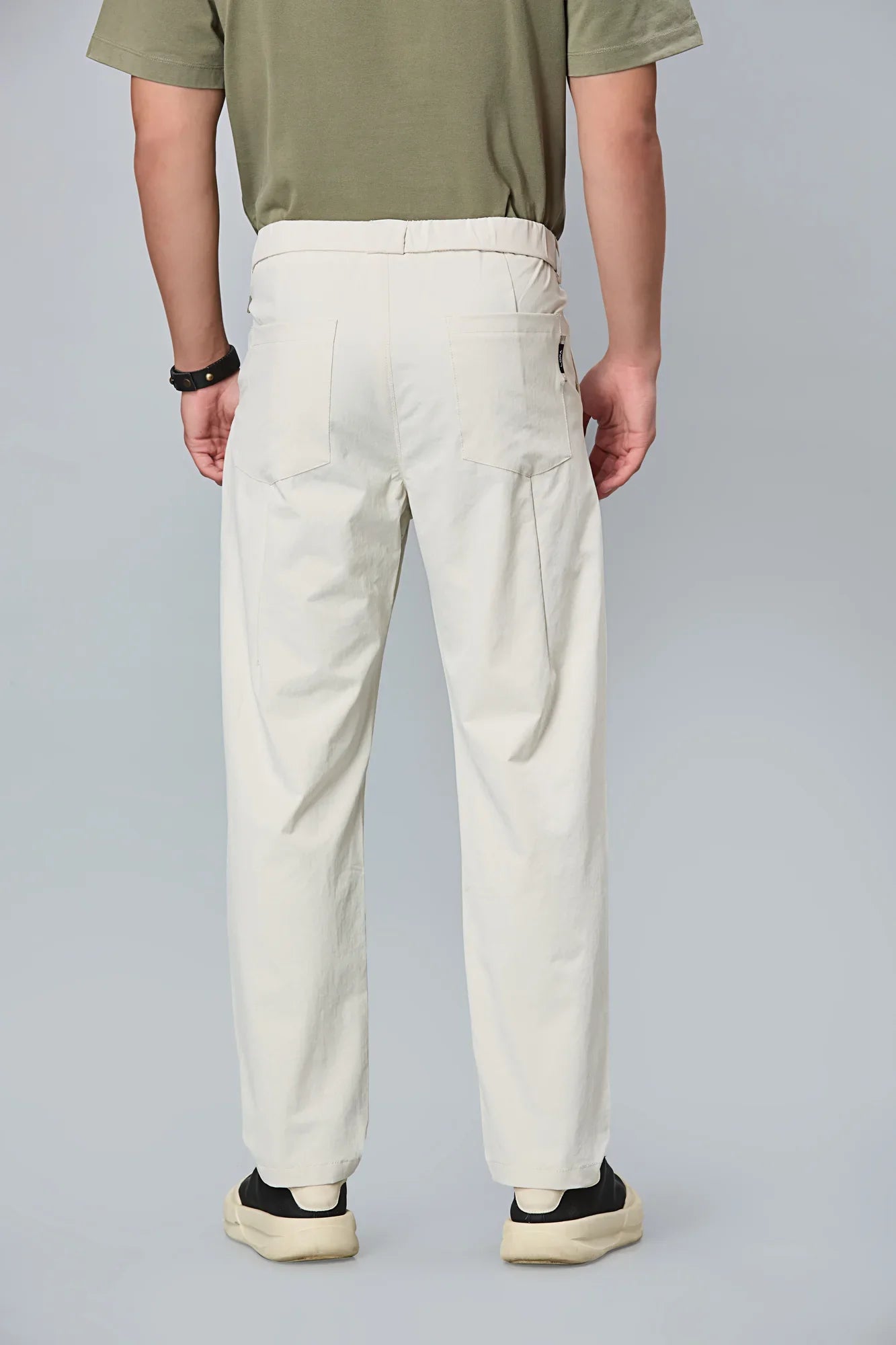 Men’s beige formal trousers back view – 100% polyester with elastic waist.