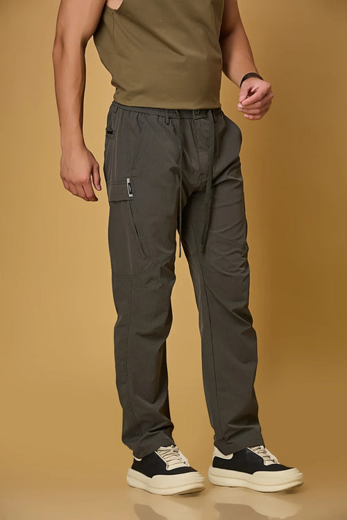 grey stretchable trousers side view showing two side pockets and relaxed fit.